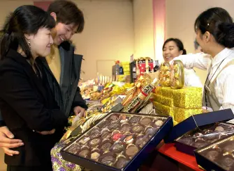  This photo shows the twist in Valentine’s Day in South Korea. The woman is participating in the chocolate tradition by making sure to get her significant other some of his favorites. 
