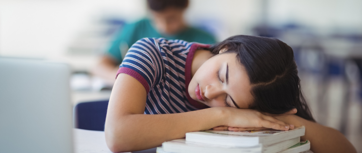 A student falls asleep during class. This student probably didn’t get enough sleep the night before. 