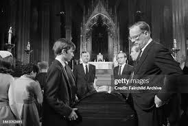 A young RFK Jr. (left) stands at his father's casket. 