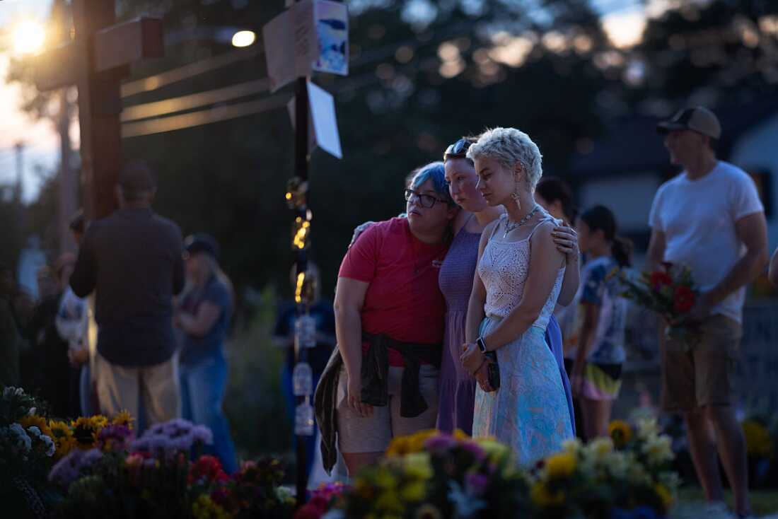 MINNEAPOLIS, MINNESOTA - AUGUST 28: People gather at a memorial for victims of yesterday's shooting in front of Annunciation Catholic Church on August 28, 2025 in Minneapolis, Minnesota. A gunman fired through the windows of the church while students were sitting in pews during a Catholic school Mass, killing two children and injuring at least 17 others. The gunman reportedly died at the scene from a self-inflicted gunshot wound, according to police. (Photo by Scott Olson/Getty Images)