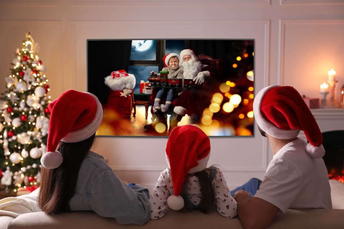 The family creates memories as they are watching their favorite Christmas movie, laughing and giggling together as they celebrate Christmas.

