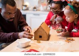 Here we have a family who is very focused on building their gingerbread house due to the fact that is has to be done quick in order for the house to not fall! It is a very focused task. 
 